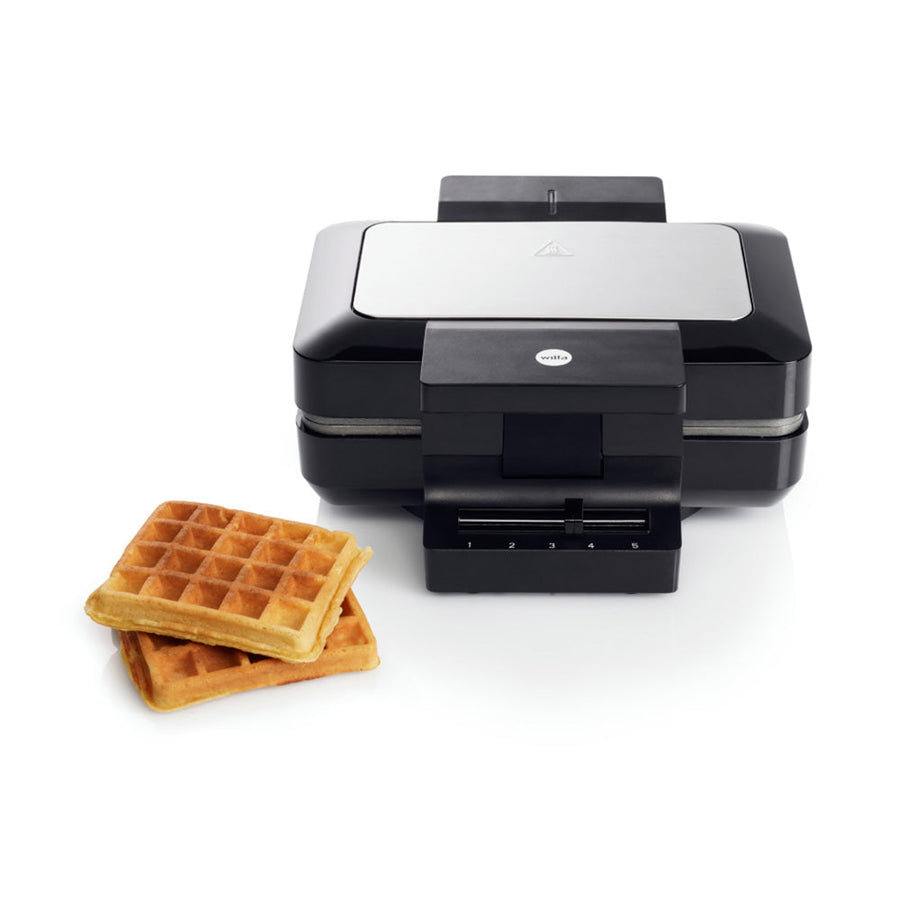 Waffeleisen in geschlossenem Zustand mit einstellbarer Bräunungsstufe, daneben zwei goldbraune Waffeln für frischen Genuss zuhause.